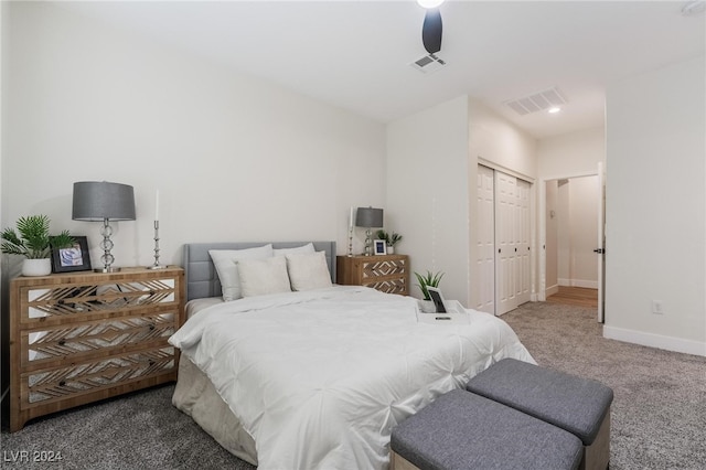 carpeted bedroom with ceiling fan and a closet