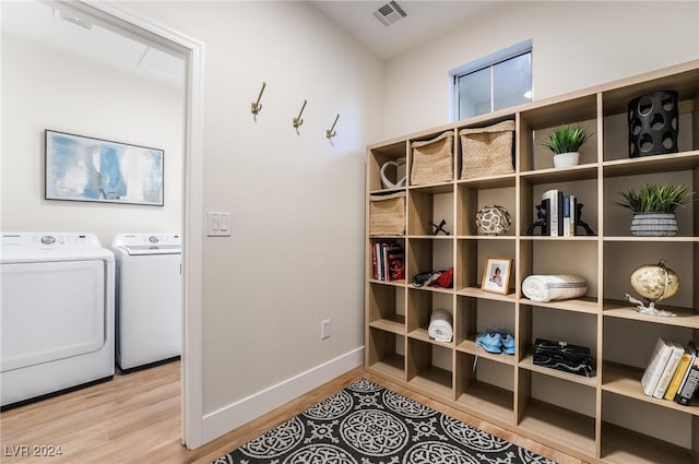 laundry room with hardwood / wood-style floors and independent washer and dryer