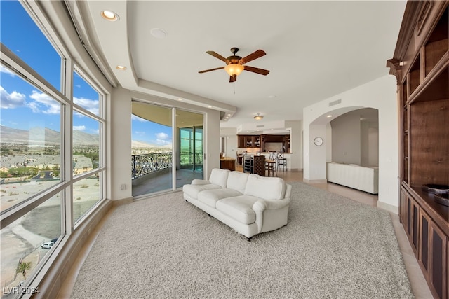 living room featuring a mountain view and ceiling fan