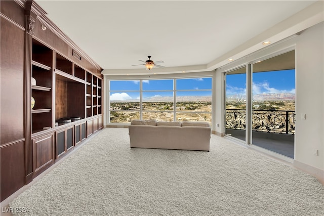 unfurnished sunroom featuring ceiling fan