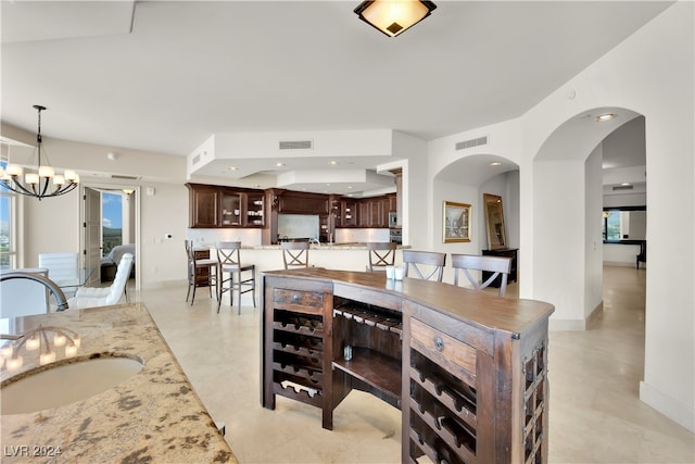 dining room with a chandelier and sink