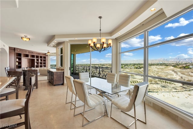 dining space featuring plenty of natural light and ceiling fan with notable chandelier