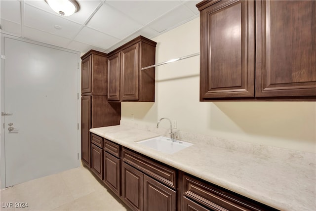 interior space with light tile patterned floors and sink