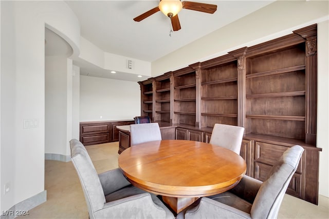 dining room with ceiling fan and built in features