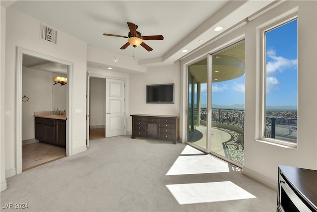 unfurnished living room with ceiling fan with notable chandelier, sink, and light carpet