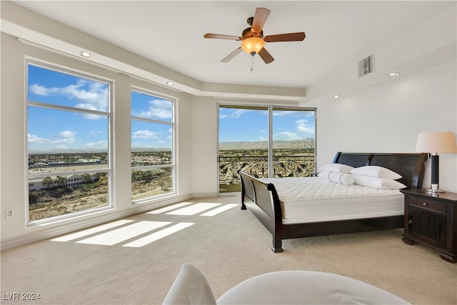 carpeted bedroom with ceiling fan and access to exterior