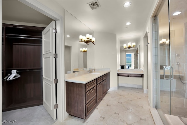 bathroom featuring vanity, independent shower and bath, and an inviting chandelier