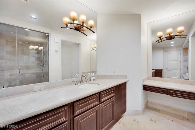 bathroom featuring a shower with door, vanity, and a chandelier