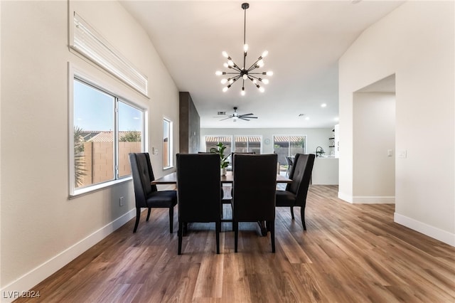 dining space featuring a healthy amount of sunlight, ceiling fan with notable chandelier, and hardwood / wood-style flooring