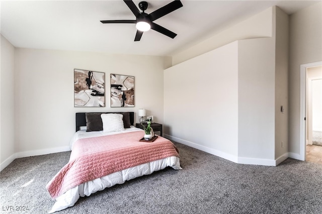 bedroom with ceiling fan, carpet floors, and lofted ceiling