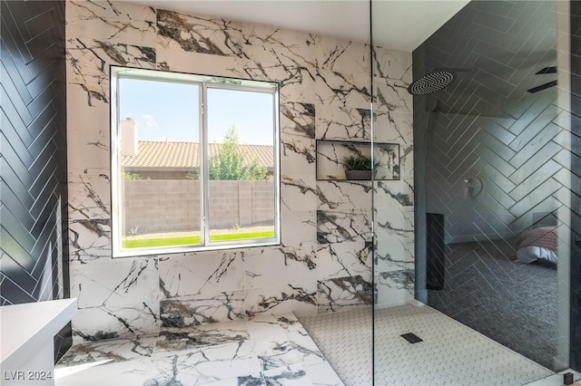 bathroom featuring tiled shower and tile walls