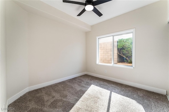 spare room with ceiling fan and carpet