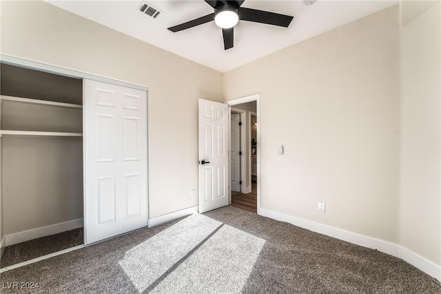 unfurnished bedroom with carpet, ceiling fan, and a closet