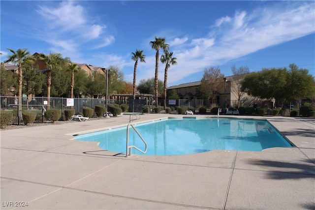 pool featuring a patio area and fence