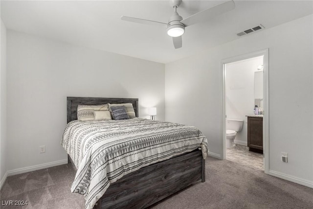 carpeted bedroom with a ceiling fan, visible vents, connected bathroom, and baseboards