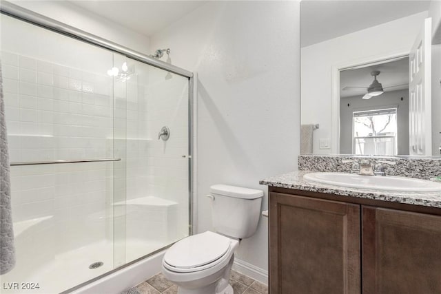 bathroom featuring vanity, toilet, baseboards, and a stall shower