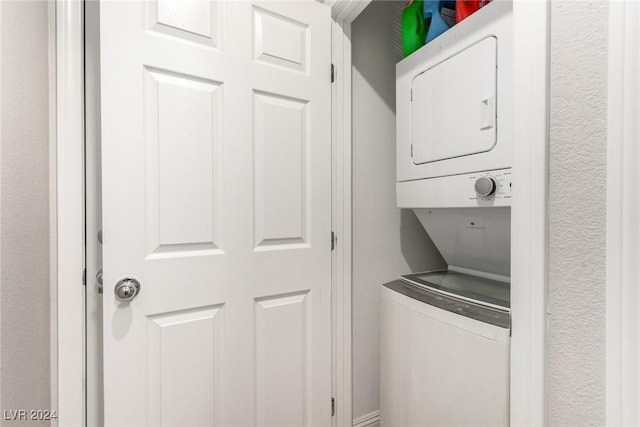 clothes washing area with laundry area and stacked washer / dryer