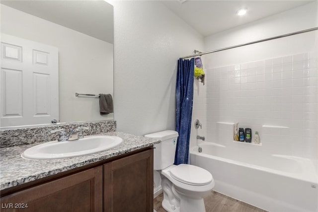 full bath with toilet, wood finished floors, vanity, and shower / tub combo with curtain