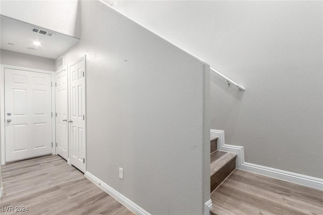 interior space with visible vents, wood finished floors, and baseboards