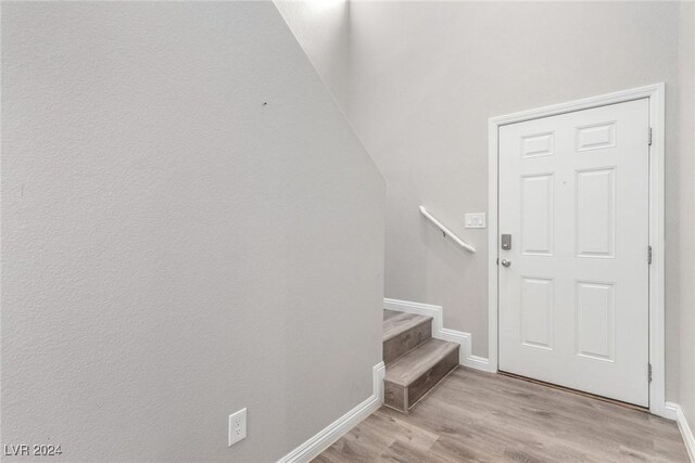 interior space with baseboards and wood finished floors