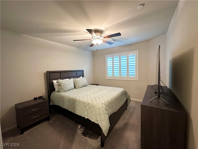 bedroom featuring ceiling fan, visible vents, dark colored carpet, and baseboards