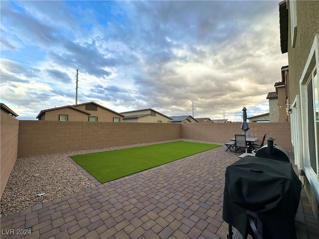 view of patio / terrace featuring a fenced backyard and a grill