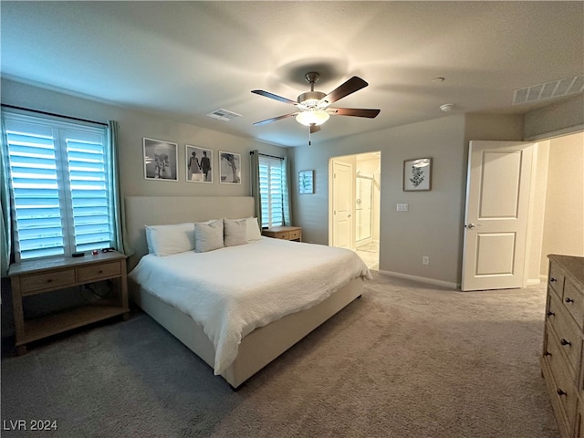 carpeted bedroom with ceiling fan, multiple windows, and visible vents