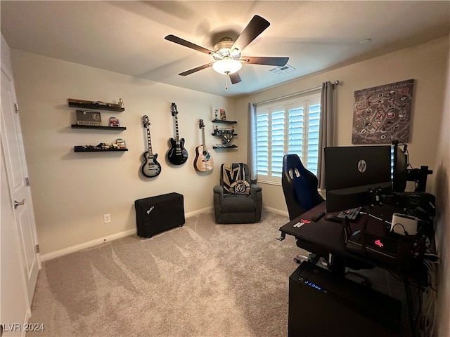 carpeted office with a ceiling fan, visible vents, and baseboards