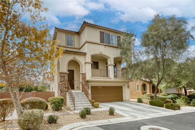 mediterranean / spanish home featuring a balcony, stucco siding, concrete driveway, a garage, and a tile roof