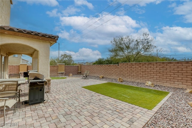 view of patio featuring a grill