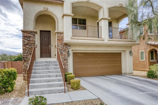 view of front of property featuring a garage and a balcony