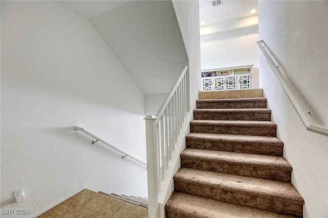 stairway with recessed lighting and visible vents