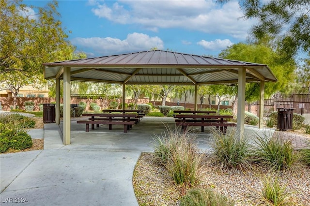 surrounding community with a gazebo, fence, and a patio area