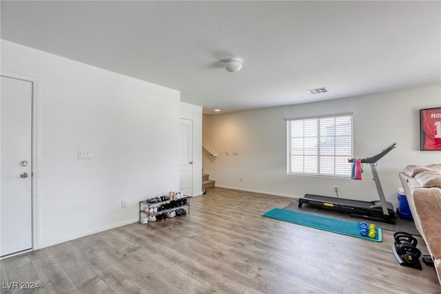 workout room with visible vents and wood finished floors