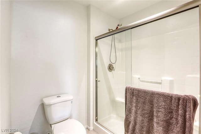 full bath with toilet and a stall shower