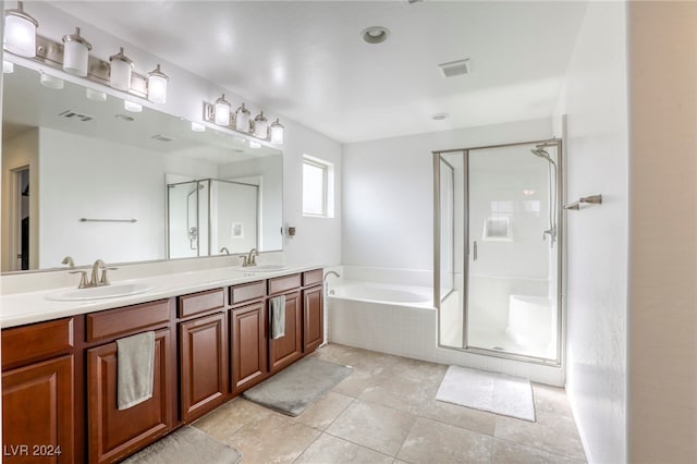 bathroom featuring tile patterned floors, vanity, and plus walk in shower