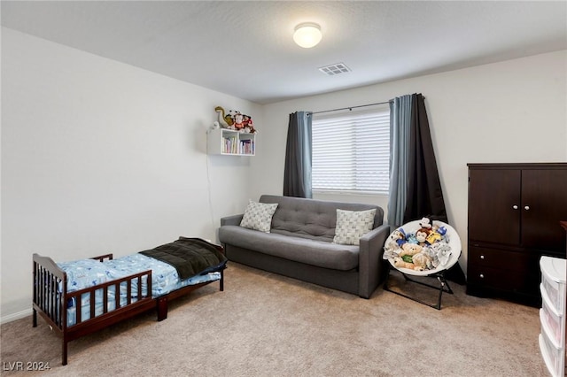 carpeted bedroom featuring visible vents