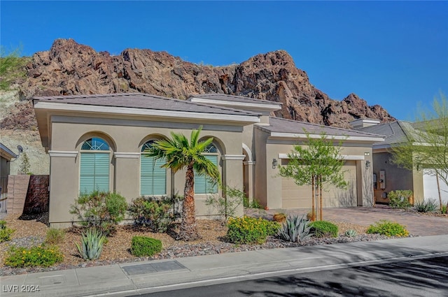 view of front of home with a mountain view and a garage