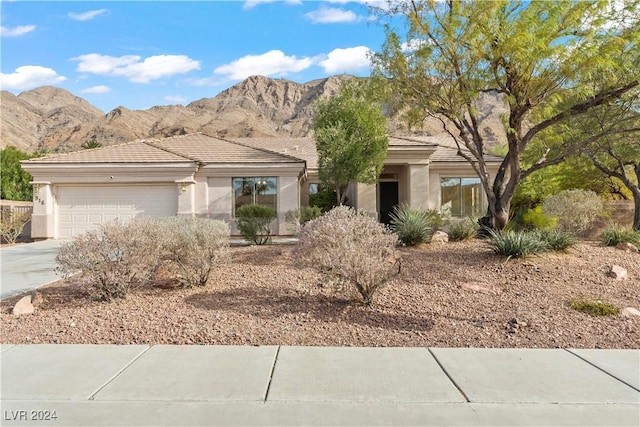 view of front of property with a mountain view and a garage