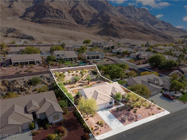 birds eye view of property with a mountain view