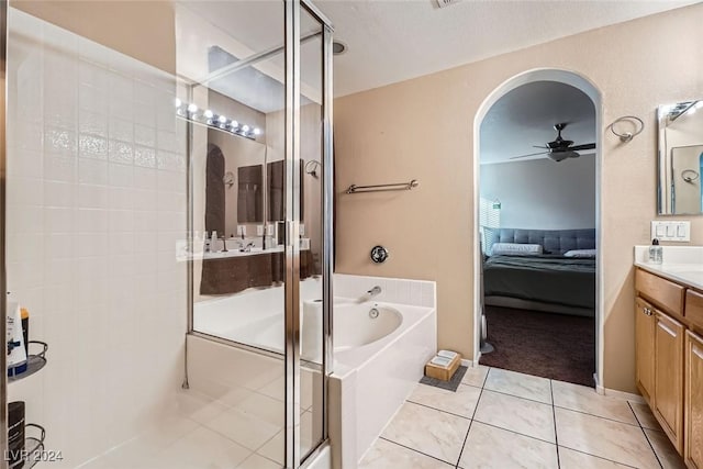 bathroom with vanity, ceiling fan, tile patterned floors, and plus walk in shower