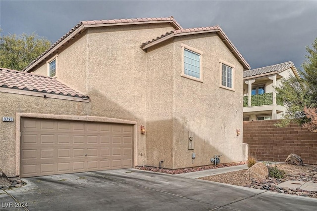 view of side of home featuring a garage