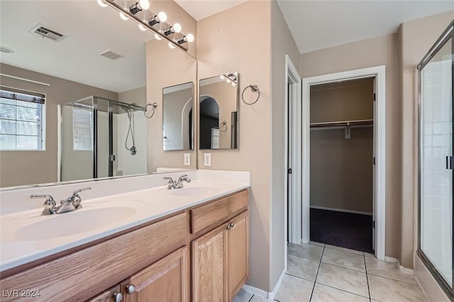 bathroom featuring vanity, an enclosed shower, and tile patterned flooring