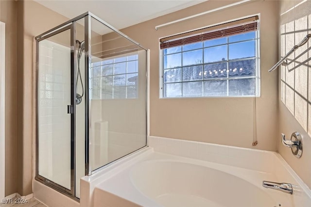 bathroom with independent shower and bath and tile patterned flooring