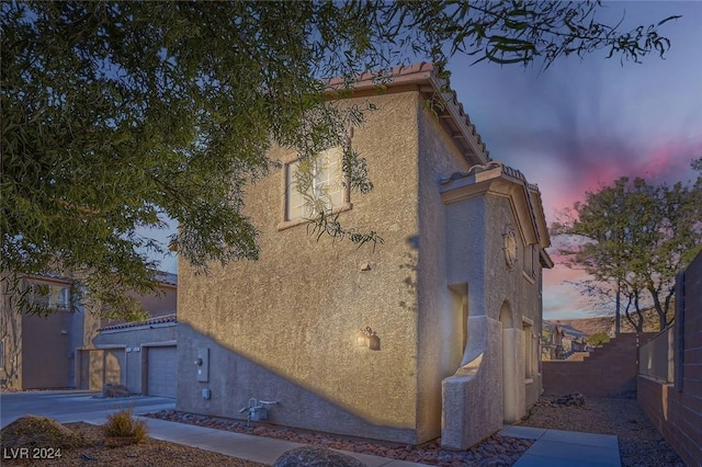 property exterior at dusk with a garage