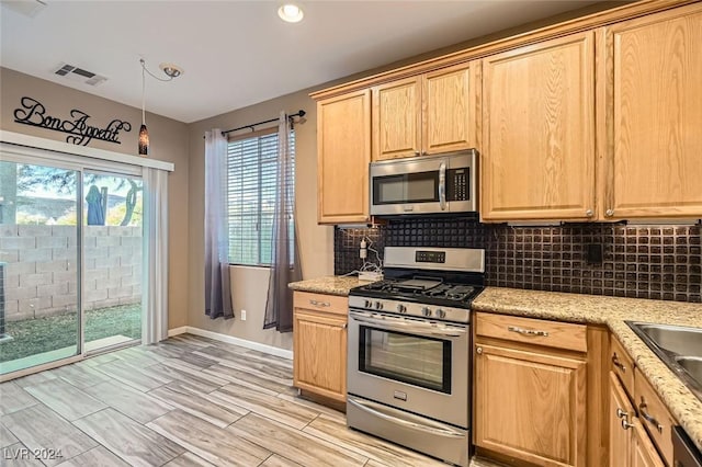 kitchen featuring light brown cabinetry, hanging light fixtures, tasteful backsplash, light stone counters, and stainless steel appliances