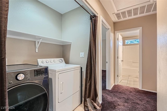 clothes washing area with light carpet and separate washer and dryer