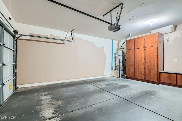 garage featuring strapped water heater and a garage door opener