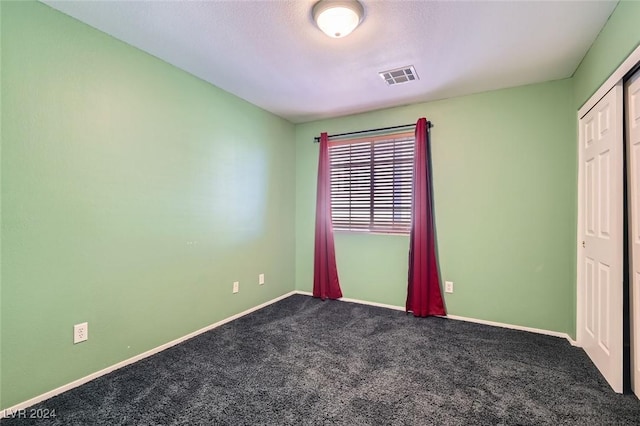 unfurnished bedroom with a closet and carpet flooring