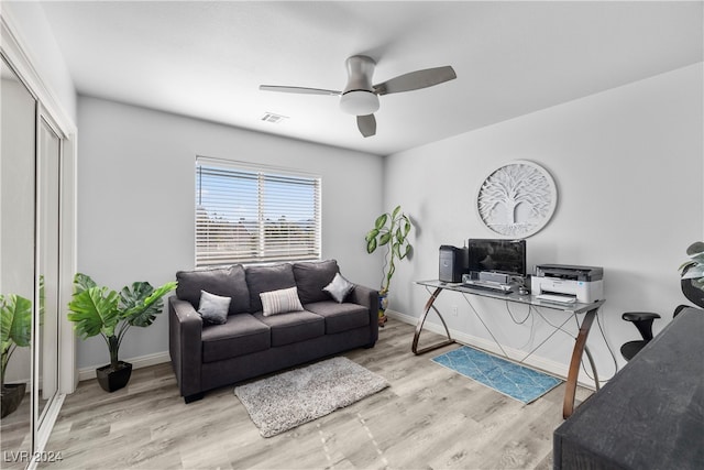 living room with ceiling fan and light hardwood / wood-style floors